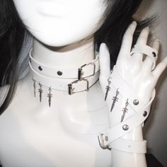 This double-wrap choker is a statement piece that adds an edgy flair to any outfit. The choker features stud embellishments and a distinctive sword pendant, creating a bold and unique look.  Please note that the price includes one choker only. Edgy Metal Choker For Cosplay, Alternative Metal Choker For Cosplay, Adjustable Punk Choker For Cosplay, Adjustable Punk Style Choker For Cosplay, Adjustable Metal Choker For Cosplay, Alternative Style Choker For Cosplay, Adjustable Emo Choker For Cosplay, Edgy Silver Choker For Cosplay, White Punk Jewelry For Festival