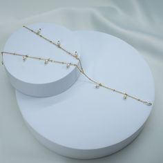 add a subtle touch to your look with our Sun Is Shining Lariat Necklace. expertly crafted for a soft and elegant look, this necklace is the perfect accessory when you want to make a delicate statement. 18k gold pvd over 316L stainless steel 4mm glass pearls water & tarnish resistant 15.5" long + 2" extender 3.5" long drop Elegant Lariat Necklace, Tarnish Resistant, Elegant Tarnish Resistant Lariat Necklaces, Elegant Tarnish Resistant Lariat Necklace, Gold Dainty Backdrop Necklace With Pearl Chain, Dainty Gold Backdrop Necklace With Pearl Chain, Gold Long Drop Lariat Necklace With Pearl Chain, Delicate Gold Lariat Chain Necklace, Elegant Gold Plated Dangle Lariat Necklace, Dainty Gold Backdrop Necklace With Clavicle Chain