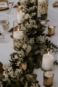 a long table with candles and flowers on it