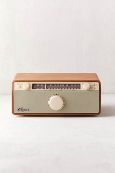 an old radio sitting on top of a white table