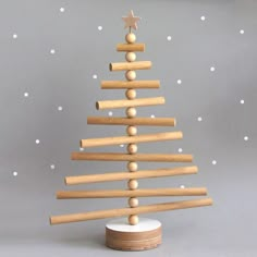 a small wooden christmas tree on a stand