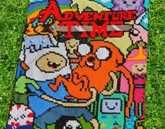 the adventure time blanket is laying in the grass