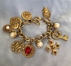 "Hello and Welcome to LiamBySevanna! Prior-purchasing any listing from this shop, please Ask question/s, Request additional photos, to make sure the listed item, is the right choice for you! Per our store policy we don't accept returns Listing is for: 1980 French Etruscan Gold toned Charm Bracelet Etruscan thyme.  Chain width: 3/8\"  Chain length: 7\" (best fit for 6.5\" wrist)  Color: Worn off Gold tone cable link chain, charms are also worn off and both chain and charms does have discolored & worn off to its gold toned areas, accented with mixed charms, including crown, lock, heart, key, Maltese cross, and more. Reminder: You can \"always\" prevent any wrong purchase/s by Communicating, Inquiring and Questioning Prior making any Purchase! We provide pictures and share any info known abou Xoxo Jewelry, Dope Jewelry Accessories, Jewelry Tattoo, Dope Jewelry, Gold Charm Bracelet, Stacked Jewelry, Jewelry Lookbook, Funky Jewelry, Girly Jewelry