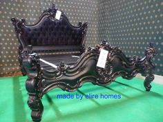 an ornate black bed frame is on display