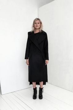 "Premium quality Black woolen coat has an oversize silhouette through the body , crafted in a heavy and thick high quality Italian wool fabric. Calf-length coat is fastened with two knobs. The coat has a unique cut , features big collar, long sleeves and is very stylish. This coat has a horizontal line through the front and back, there are large pockets in front. On one side on the shoulder is a decorative detail. The coat is with viscose lined. This coat is very stylish and unique created by a Black Wool Coat With Lapel Collar For Fall, Oversized Black Wool Blazer, Black Oversized Long Outerwear, Chic Black Wool Coat, Oversized Long Black Outerwear, Black Long Oversized Outerwear, Chic Black Long Sleeve Wool Coat, Chic Black Structured Wool Coat, Oversized Black Long Coat Blazer