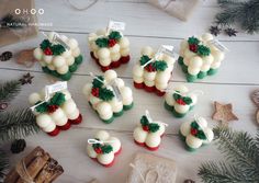 christmas themed cupcakes are arranged on a table