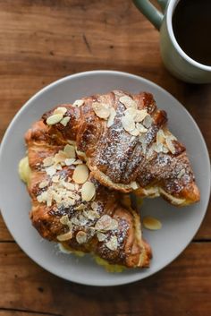 three pastries on a plate with coffee