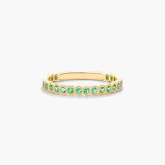 Crafted in 14K yellow gold, this contemporary band featuring bezel set round-cut emeralds with delicate milgrain detail is chic and timeless. Wear this brilliant band on its own or mix and match with other stackables for a fashion forward look. Elegant Emerald Ring With Bezel Setting, Elegant Emerald Ring With Smooth Bezel For Anniversary, Elegant Gold Emerald Ring With Smooth Bezel, Birthstone Wedding Band, May Birthstone, Engagement Bands, Vintage Band, Engagement Ring Styles, Matching Band