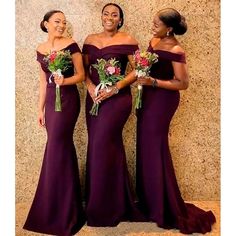 three women in long purple dresses standing next to each other and smiling at the camera