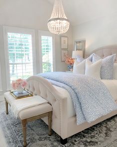 a white bed sitting in a bedroom next to a window