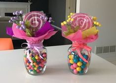 two vases filled with candy and candies on a table