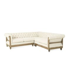 a white sectional couch sitting on top of a wooden table