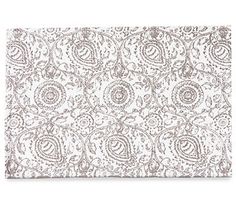 a white and brown placemat with an intricate design on it's surface,