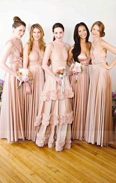 a group of women standing next to each other on top of a hard wood floor