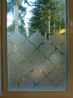 an image of a glass window with trees in the background