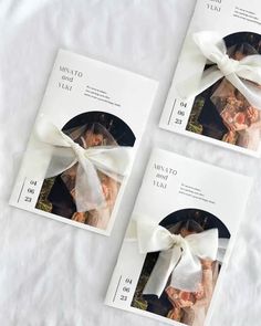 three wedding cards with white bows on them