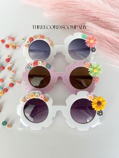 This listing is for one pair of flower sunglasses with personalization, and floral charms. It is made to order. Flower accent colors will vary and will be placed as seen fit. If you would like specific colors, please message me. These personalized sunglasses are perfect for most toddlers and children aged 2 to 6. NOTE: For children under 3, use only under the supervision of an adult. Beads can cause a choking hazard, if left unattended. **Because of personalization, the item may not be returned/exchanged** Please make sure to double check your order before submitting. Each pair can accommodate up to 12 letters, providing you with the opportunity to create a unique pair of sunglasses for your little one. Please keep in mind that the sunglasses may slightly vary in color due to different scr White Cute Sunglasses For Birthday, White Sunglasses For Spring Gift, Sunglasses Party Favor, Sunglasses Party, Personalized Sunglasses, Party Favors Birthday, Flower Sunglasses, Favors Birthday, Girl With Sunglasses