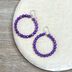 Create effortless style with these 2-inch hoop earrings crafted from beautiful natural Phosphosiderite beads in vibrant purple hues. Elevate your basic jeans and tee or complete your look with the timeless beauty of natural gemstones. The solid Sterling Silver 925 hardware ensures durability and elegance. Packaged in a fine cotton jewelry pouch, these artisan earrings are ready for gifting. 🌟AAA Natural Purple Phosphosiderite in vibrant shades of purple  🌟Solid Sterling Silver 925 hardware for lasting quality and durability  🌟2.5 inch total length length and 2 inch hoop width  🌟Packaged in a cotton gift pouch 🌟Handmade in the USA 🤍✨ Basic Jeans, Cotton Jewelry, Pouch Handmade, Cotton Gift, Artisan Earrings, Vibrant Purple, Cotton Gifts, Earring Crafts, Beaded Hoop Earrings