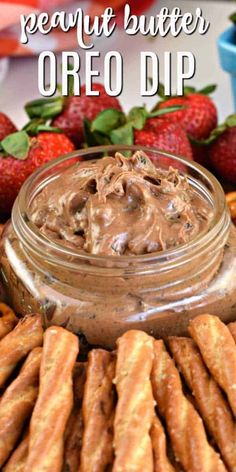 chocolate peanut butter oreo dip in a jar with strawberries on the side