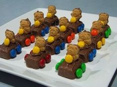 there are many teddy bears riding on a train made out of chocolate candies and candy