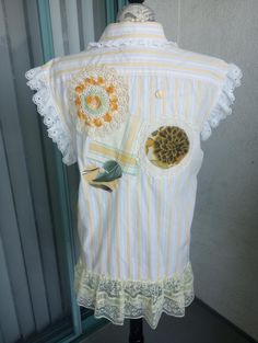 a woman's shirt with lace and buttons on it