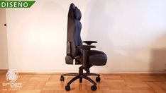 an office chair sitting on top of a hard wood floor next to a white wall