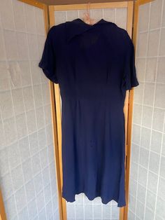 "1940's navy blue shirt sleeve dress with two rows of asymmetrical buttons. Also has an asymmetrical back collar. Metal side zipper, very structurally sound but has a few small holes/scrapes on the butt and a couple on the center bodice as well, see photos Bust: 40\" Waist: 32\" Hips: 42\" Skirt length: 27\"" Navy Blue Shirt, Navy Blue Shirts, Decorative Buttons, Short Sleeve Dress, Blue Shirt, Skirt Length, Shirt Sleeves, Side Zipper, Lincoln