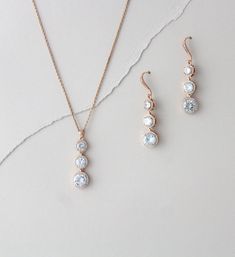 "Elegant graduated halo CZ Rose gold Bridal necklace set is full of sparkle and sophistication. A perfect selection for the bride or bridesmaids. Earrings measure 1.875\" Necklace measures 16 inches and extends to 18 inches Earring wires are sterling silver base Matching bracelet: https://www.etsy.com/listing/385433484/rose-gold-bridal-bracelet-round-halo?ref=shop_home_active_15&pro=1 Back to my shop: https://www.etsy.com/shop/TheExquisiteBride?ref=condensed_trust_header_title_items Browse o Rose Gold Round Jewelry Sets For Weddings, Delicate Rose Gold Bridesmaid Jewelry, Gold Jewelry Bridal, Rose Gold Bridesmaid Jewelry, Rose Gold Necklace Set, Bridal Earrings Rose Gold, Gold Bridesmaid Jewelry, Rose Gold Statement Earrings, Gold Necklace Wedding