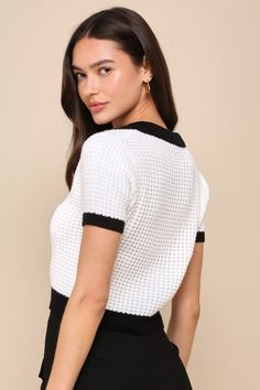 The Lulus Poised Achievement Ivory and Black Short Sleeve Collared Sweater is ready to have everyone taking note of your iconic aesthetic! Lightweight waffle-textured knit shapes this adorable sweater that boasts a contrasting, color block-inspired design with black accents throughout. Short sleeves frame a collared neckline that sits atop a lightly fitted bodice with a functional button placket at the front. Ribbed knit accents the neckline, cuffs, and hem. Fit: This garment fits true to size. Short Sleeve Sweater Outfit, Iconic Aesthetic, Collared Sweater, Wedding Top, Chic Sweaters, Short Sleeve Sweater, Collar Sweater, Black Accents, Textured Knit