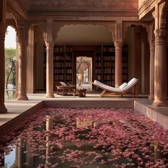 a room filled with lots of pink flowers next to a book shelf full of books