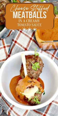 meatballs in a creamy tomato sauce on a white plate with text overlay that reads cheese stuffed meatballs in a creamy tomato sauce