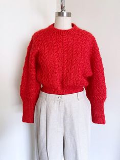 Super cute cropped red sweater. Features a beautiful red color, dolmen sleeves, banded hems, and a wool blend material.  Era: 80's    Label: None, handmade  Size Marked: None      Estimated Size: M/L Material: Wool Blend/Mohair Condition: Excellent Measurements:  -Chest: 19"-21" stretch -Waist: 14"-17" stretch -Sleeve: 24"-from neckline to hem -Length: 21 1/2" To see more items please visit: http://www.etsy.com/shop/wemovevintage Please see our policies prior to purchase. No refunds or exchanges. Please read all measurements carefully Http://www.etsy.com/shop/wemovevintage/policy Please let us know if you have any questions! WEMOVEVINTAGE Cropped Red Sweater, Sweater Ideas, Red Sweater, Red Wool, Wool Blend Sweater, Red Sweaters, Women Pullover, Festival Season, Red Color