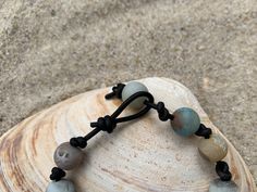 Matte Amazonite beads are hand knotted onto leather cord for a beachy, boho bracelet. A versatile bracelet that looks great at work or play! No more worrying about switching out jewelry for a night out after work. Choose the leather cord color of your new favorite bracelet. Leather jewelry also doesn't tangle as easily which is a big plus for travel. Order yours today!Please note the bracelets in the photos are representative of your bracelet. Amazonite naturally has varying shades in the stone Bohemian Adjustable Cord Bracelet For Meditation, Earthy Style Bracelets With Sliding Knot For Beach, Adjustable Natural Stone Beaded Bracelets For Vacation, Earthy Beach Bracelets With Sliding Knot, Adjustable Hand Wrapped Leather Bracelet With Round Beads, Earthy Sliding Knot Bracelets For The Beach, Adjustable Hand-strung Leather Bracelet With Round Beads, Adjustable Hand-wrapped Beaded Leather Bracelet, Earthy Hand Wrapped Bracelets For Beach