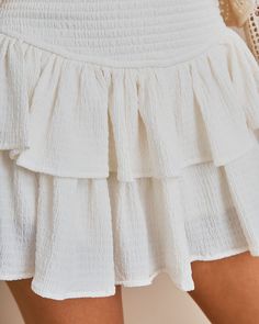 Best Seller Fit & Flowy Shellââ‚?5% Polyester and 5% Spandex and Liningââ‚?100% Rayon Hand Wash Cold. Dry Flat Mini Length Smocked Waistband Tiered Skirt No Closures Fully Lined //Best Seller//Show off your legs in the Queensland Smocked Ruffle Mini Skirt in white that features dramatic ruffles.Styled with: Shelly Sweater and Dev Bootie. ---SIZE AND FIT---Model is Wearing a Size Small. Height is 5'7"". Bust is 32ââ‚? Waist 25ââ‚? and Hips 30ââ‚?/span> Size XS: Length measures 13.5ââ‚?from waist to hem with a 20ââ‚?waist and a 25ââ‚?hip Size S: Length measures 14ââ‚?from waist to hem with a 22ââ‚?waist and a 26ââ‚?hip Size M: Length measures 15ââ‚?from waist to hem with a 24ââ‚?waist and a 27ââ‚?hip Size L: Length measures 15ââ‚?from waist to hem with a 26ââ‚?waist and a 28ââ‚?hip Need Addi Ruffle Mini Skirt, Skirts For Women, Tier Skirt, Tiered Skirt, Trending Now, Queensland, Best Seller, Bootie, Smocking