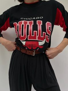 Our absolute favorite Chicago Bulls sweatshirt! Features the classic Chicago Bulls red coloring in the ribbed neckline and inner sleeves. The middle front of the sweatshirt showcases a beautiful print with the Chicago Bulls Logo. The perfect piece to pair with the AGOLDE 90's Pinch Waist Jean. 50% polyester 50% cotton Tag reads Official Licensed Product NBA - Made in USA Recommended for size xs-s, depending on the desired fit. Modeled on a small frame. Please refer to the measurements listed bel Winter Varsity Long Sleeve T-shirt, Winter Streetwear Tops With Raglan Sleeves, Fall Raglan Sleeve T-shirt For Streetwear, Fall Graphic Print Sweatshirt With Raglan Sleeves, Red Graphic Print Raglan Sleeve Top, Red Raglan Sleeve Tops With Graphic Print, Fall Streetwear Tops With Raglan Sleeve, Raglan Sleeve Tops For Fall Streetwear, Red Varsity Top With Ribbed Cuffs