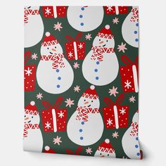 a christmas wrapping paper with snowmen and presents on it's green background,