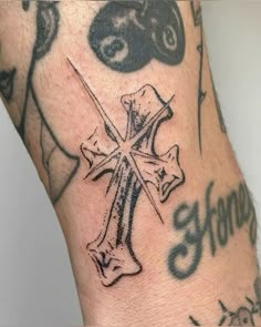 a man with a cross tattoo on his arm