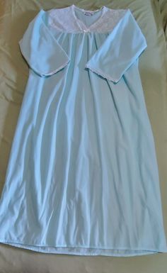 This vintage Anthony Richards nightgown is a beautiful addition to any wardrobe. The delicate light blue color and lace trim add a touch of femininity to the comfortable polyester material. The dress has a cottagecore look and is perfect for those who love vintage clothing.  The nightgown is a size 1X, with a chest size of 26 inches and a waist size of 28 inches. The shoulder to shoulder measurement is 18 inches, and the shoulder to hem length is 50 inches. This original piece was made in Haiti and is sure to be a treasured addition to any collection. Blue Lace Trim Nightgown For Sleep, Blue Lace Nightgown With Lace Trim, Light Blue Lace Trim Nightgown, Blue Vintage Cotton Nightgown, Blue Sheer Vintage Sleepwear, Richard Long, Pajama Dress, Women's Nightgowns, Love Vintage