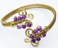 Introducing our enchanting Brass Shoulder Bracelet with Purple Agate Stones - a true embodiment of artisan craftsmanship. This meticulously handcrafted piece seamlessly blends the warmth of brass with the allure of purple agate stones, creating a unique accessory that captivates the senses. The shoulder bracelet features a delicate and adjustable design, ensuring a comfortable fit that elegantly drapes over your shoulder. The intricate brass detailing adds a touch of sophistication, while the vi Spiritual Purple Jewelry With Unique Variations, Purple Wire Wrapped Bracelets As Gift, Unique Adjustable Amethyst Bracelets, Unique Purple Bracelets For Gift, Unique Handmade Amethyst Bracelets, Hand Wrapped Purple Bracelets As Gift, Bohemian Gold Amethyst Beaded Bracelets, Gold Bohemian Amethyst Beaded Bracelets, Bohemian Gold Beaded Amethyst Bracelets