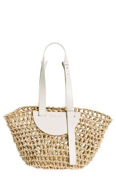 Woven from palm leaves using techniques from Darfur, Sudan, and trimmed with Italian leather, this bag will accompany you from the city to the beach. Bridge-clip closure Shoulder straps Removable tethered zip pouch Doum palm/leather Imported Designer Handbags Black Owned/Founded Summer Natural Straw Bag With Detachable Strap, Modern Woven Leather Beach Bag, Natural Straw Tote Bag With Detachable Strap, Beach Bags With Detachable Strap In Straw, Beach Straw Bag With Detachable Strap And Double Handle, Modern Woven Shoulder Bag For Vacation, Modern Woven Leather Shoulder Bag For Beach, Modern Woven Leather Beach Shoulder Bag, Luxury Open Weave Straw Bag For Summer