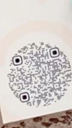 a close up of a piece of paper with a qr code printed on it