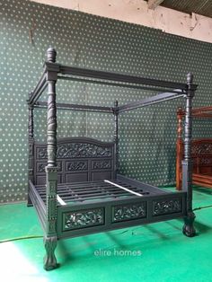 an antique bed frame is shown in the middle of a room with green flooring