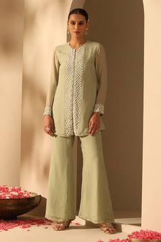 Sage green tunic with pearl embroidered placket. Comes with flared pant.
Components: 2
Pattern: Embroidered
Type Of Work: Thread,Pearl
Neckline: Round
Sleeve Type: Full
Fabric: Soft Organza
Color: Green
Other Details: 
Approx. product weight: 3 kg
Length:
Tunic: 33 inches
Pant: 40 inches
Model Height: 5ft 7inches wearing size S
Occasion: Party,Cocktail - Aza Fashions Light Embroidery, Tunic With Pants, Coordinate Sets, Cloth Designs, Smart Casuals, Pearl Work, Green Thread, Green Tunic, Pant For Women