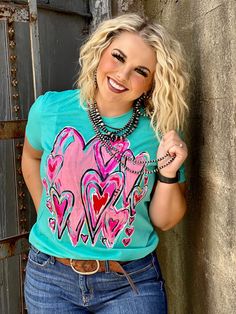 Callie's Bunches of Love Tee by Texas True Threads shown here on a Blue Short Sleeve Graphic Tee One of a kind, hand drawn design by Callie Ann Bright pops of pink, with a hint of black and red Ultra soft, bella canvas tee shirt, true to size fit Spring Blue Heart Print Tops, Blue Tops With Heart Print For Spring, Blue Heart Print Tops For Spring, Blue Heart Print Top For Summer, Blue Summer Top With Heart Graphic, Cute Printed Blue Tops, Trendy Blue Tops With Heart Graphic, Blue Cotton Tops With Heart Graphic, Blue Short Sleeve Tops With Heart Graphic