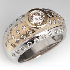 a gold and silver ring with diamonds on it