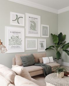 a living room with couches and pictures on the wall above them, along with a coffee table