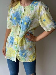 Vintage Lindex floral yellow and blue blouse in Hawaiian style for women. Retro 80s style, buttons closure light and perfect for summer and spring.  It will fit classic pants, jeans, and even a skirt. Casual style both for everyday wear and special occasions. Materials: 100% cotton Size: 40-42 / L-XL for women Era: 80s Pattern: floral Measurements: Breast 50 / 19,6 inches Waist 42 / 16,5 inches Hips 50 / 19,6 inches Length 76 / 29,9 inches The blouse is pre-owned, but it is in perfect condition. Summer Half Sleeve Cotton Blouse, Summer Cotton Blouse, Half Sleeve, Summer Cotton Blouse With Half Sleeves, Spring Summer Short Sleeve Shirt, Summer Floral Print Half Sleeve Tops, Half Sleeve Tops For Spring And Summer, Green Half Sleeve Blouse For Summer, Green Vintage Print Tops For Summer, Floral Print Half Sleeve Shirt For Spring