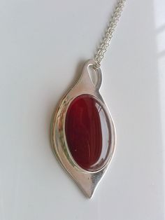 "this beautiful red carnelian is settle on a Silver tear drop hand made with sterling silver, it has a loop that can be used as bail. The stone is 18 x 25 mm and the teardrop is 0.8 mm thick, the chain is 16 inches and 1 mm thick This a special design matches with the carnelian rings that you can see in these links: http://etsy.me/1Tzy0fP http://etsy.me/1TyuVSF *This jewel will be sent to you in a gift box * All the pieces are Hand Made * Custom order We will be glad to make any size, style, oth Amber Teardrop Cabochon Necklace, Polished Teardrop Amber Necklace, Red Chalcedony Round Jewelry, Amber Teardrop Necklace With Polished Finish, Red Jewelry With Large Oval Pendant, Red Chalcedony Jewelry With Natural Stones, Red Carnelian Teardrop Necklaces, Red Carnelian Teardrop Necklace, Elegant Carnelian Oval Pendant Jewelry