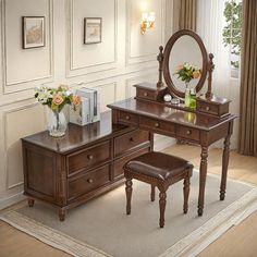 a dressing table with stool and mirror in a room