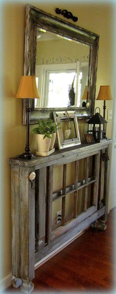 an old dresser with a mirror and lamp on top